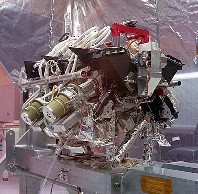 This is the "science part" of the MISR instrument, which includes the cameras and calibration equipment. The photograph was taken in October 1996, as MISR was being assembled. Subsequently, the parts that supply power, communications, and temperature control were added. The entire package was then encased in a protective housing, which was covered with highly reflecting thermal blankets.JPL Image P-28109A