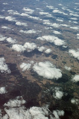 Cumulus clouds over the Midwest of the United States: A pattern of cumulus clouds casts its shadows on the farmland below, in this autumn 1991 aerial scene. MISR is able to classify clouds distributed over the entire Earth based on their height, shape, and texture.