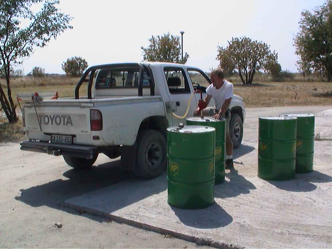 Here you see Pete pumping gas at the came. You see, our rental bakkie takes unleaded fuel.  It has a fillpipe restrictor, so even though it does not have an oxygen sensor or a catalytic converter (things which are clogged by lead), it is still difficult to put leaded fuel in it.  The spigot won't fit.
